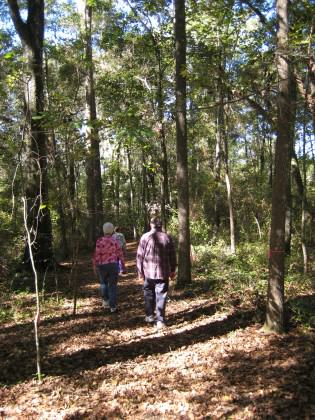 Residents enjoying a stroll through a wooded remnant in a development. Staying on trails is an important action by residents to minimize impacts on local plant and animal communities. Photo by Mark Hostetler.