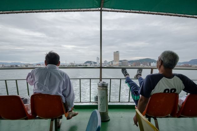 Two men leave the main city of Takamatsu, bound for Megijima on the last ferry. Photo: Patrick M. Lydon