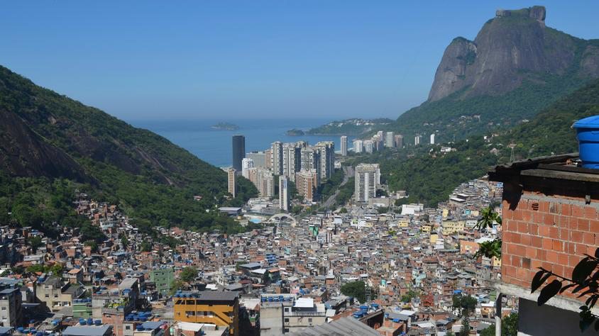 Rocinha ("little farm", due to its agricultural vocation until the mid 20th century), located in the rich southern zone of Rio de Janeiro, is considered one of the most populous favelas in Brazil. Most of its 70,000 inhabitants live in houses made from concrete and brick and have access to basic sanitation, plumbing, and electricity. The neighborhood has a vibrant local economy. Source: Alamy.com