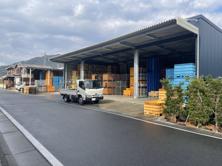 A truck parked outside of a warehouse