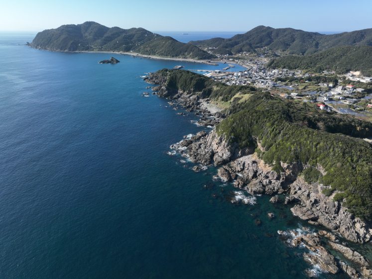 A body of water with hills and land