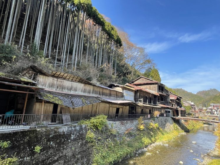 A building on a cliff by a river
