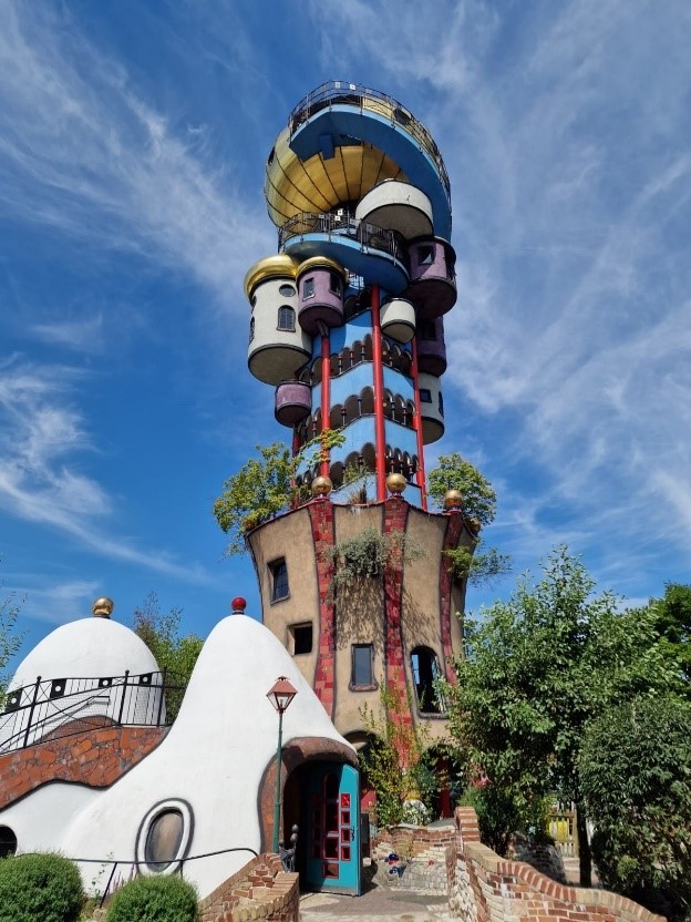 A tall colorful building with a dome and a ball on top