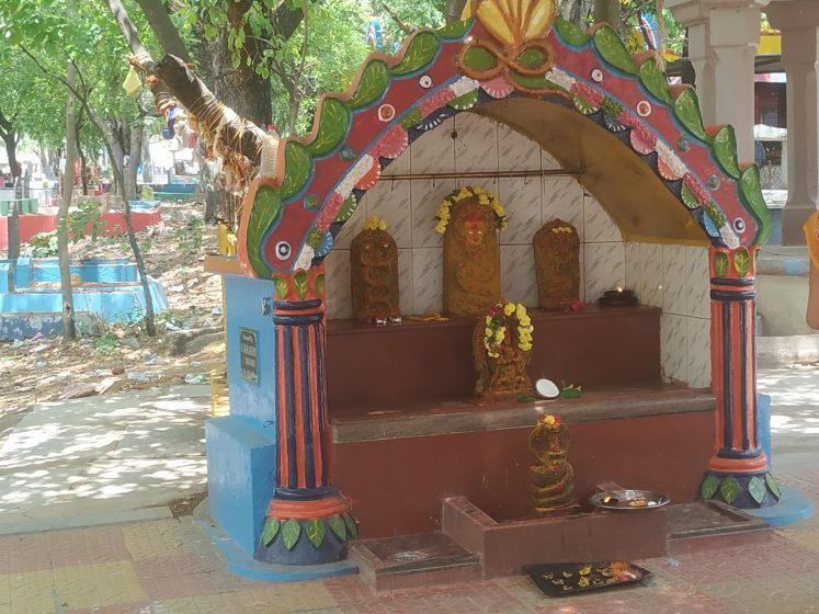 A colorful shrine with trees in the background