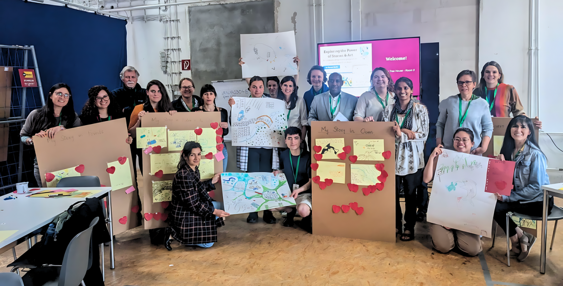 A picture of a group of people holding posters in a room