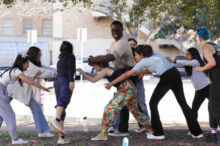 A group of play actors acting out a scene outdoors