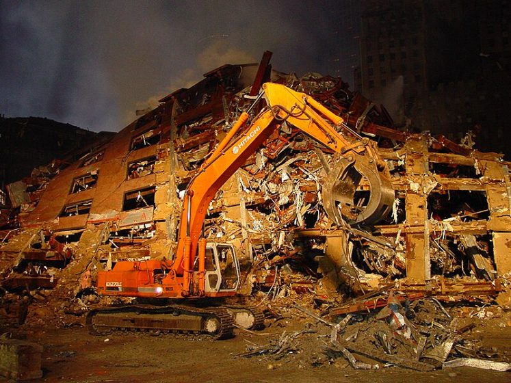 A construction vehicle with a large pile of debris