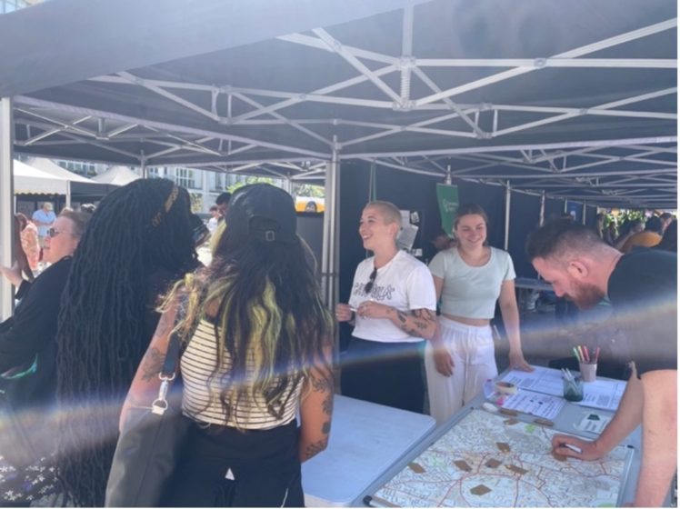 A group of people standing around a table in a large tent