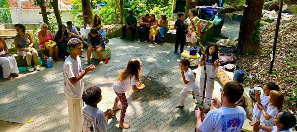 A picture of a group of young people performing a dance on an outdoor stage