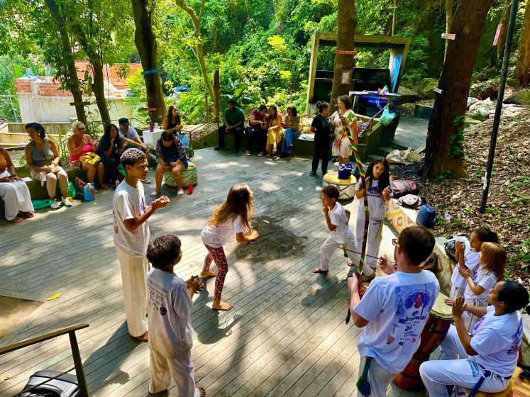 A picture of a group of young people performing a dance on an outdoor stage